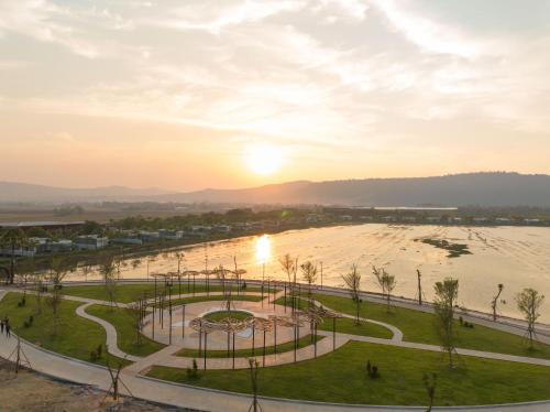 a view of a park with the sunset in the background at Wonderland Suites and Resort in Sihanoukville