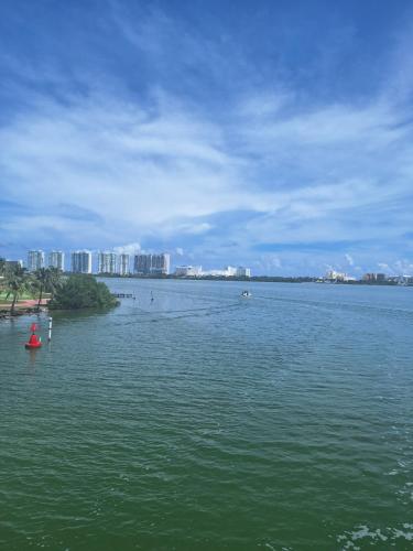 a large body of water with a city in the background at Condo Azul in Cancún