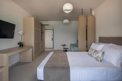 a bedroom with a large bed and a tv at Suite di Lusso in Kalamitsi