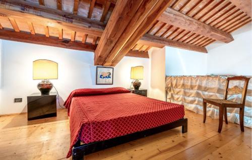 a bedroom with a red bed in a room with wooden ceilings at Ca' Dotta in Thiene