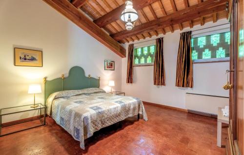 a bedroom with a bed and two lamps and windows at Ca' Dotta in Thiene