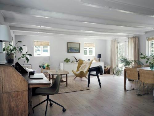a living room with a piano and chairs at Peaceful Forest Idyll In Timber House For Families in Jyderup