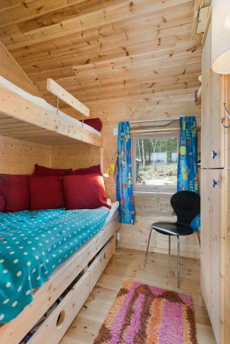 a bedroom with a bunk bed in a log cabin at Seaside Cabin With Panoramic Views In Oterstranda in Inndyr