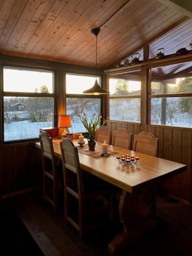 a dining room with a wooden table and chairs at Original Trybo Cabin At Trysil Mountain in Trysil