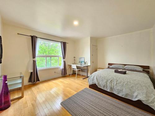 a bedroom with a bed and a window and a desk at Central Downtown Toronto - Trinity Bellwood Park in Toronto