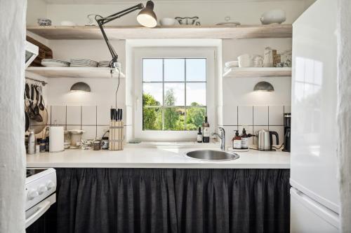 a kitchen with a sink and a window at Holiday Apartment On Hærvejen In Dollerup Hills in Viborg