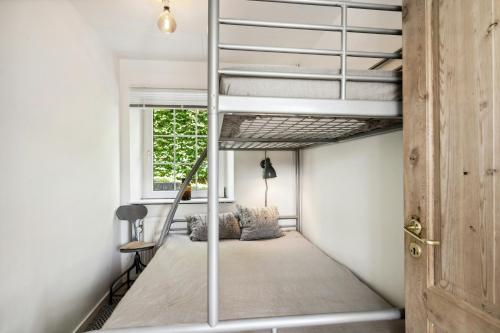 a room with a bunk bed with a ladder at Holiday Apartment On Hærvejen In Dollerup Hills in Viborg