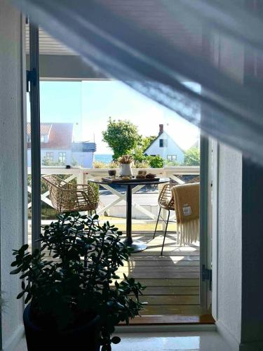 a view of a porch with a table and chairs at Idyllic House With Cliff Formations And Ocean View in Sandvig