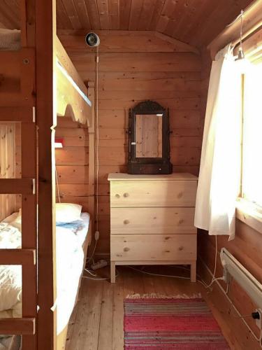 a bedroom with a bed and a dresser in a cabin at Log Cabin Near Vasaloppet Ski Trail In Gopshus in Blyberg