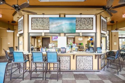 a bar with chairs in front of a store at Resort Style Condo 4 miles from Disney in Orlando