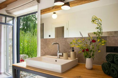 a bathroom with a white sink and a mirror at Vacation Home Near The Keezer Lake in Langen Jarchow