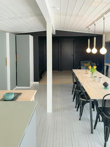 a dining room with a long table and chairs at Cabin With A Modern Touch On Tjøme in Tjøme
