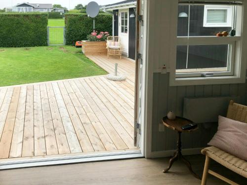 an open door to a patio with a deck at Romantic Summerhouse With Seaview in Kolding