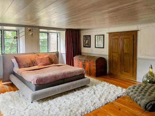 a bedroom with a large bed and a rug at 18Th-Century Limestone House In Hablingbo in Havdhem