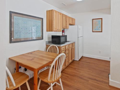 a kitchen with a wooden table and a refrigerator at 2072 - Laughing Duck in Duck