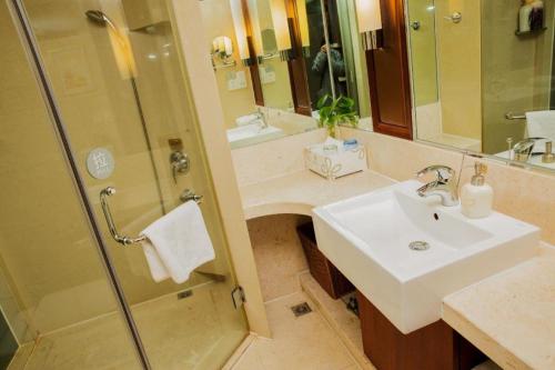 a bathroom with a sink and a shower at Jinhua World Trade Hotel in Jinhua