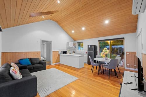 a living room with a couch and a table at Cozy 2BR Cottage Near Beach & Village Shops in Balnarring