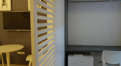 a room with a desk and a table and a table and chairs at Hotel Monde in Dagupan