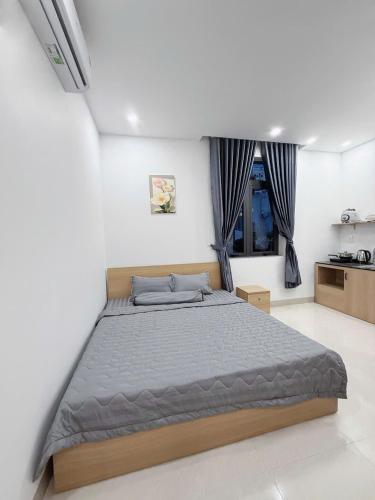 a bedroom with a large bed in a room at Nami House in Da Nang