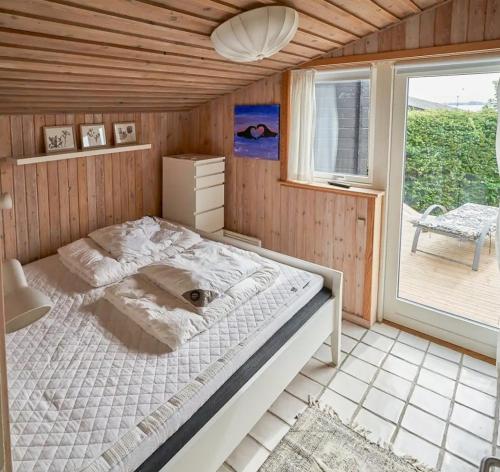 a large bed in a room with a window at Cozy Beach House With Sea View In Gråsten in Gråsten