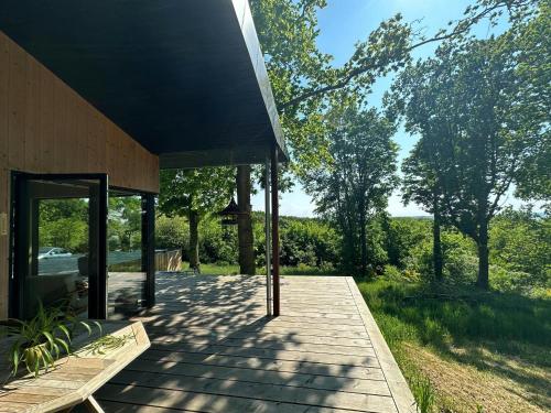 a house with a wooden walkway outside of it at Elevated House With Tremendous View Near Horsens in Odder