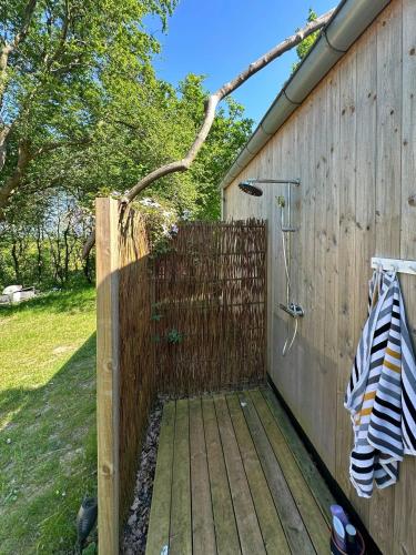 a wooden fence next to a building with a gate at Elevated House With Tremendous View Near Horsens in Odder