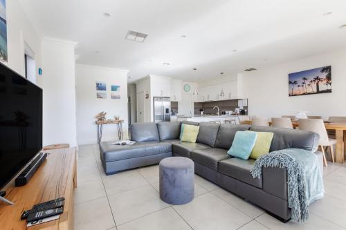a living room with a couch and a table at Sullivan Villa - Spacious Modern Escape by Rye Beach in Rye