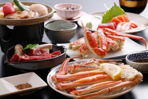 a table with plates of different types of food at Yoshiharu in Toyooka
