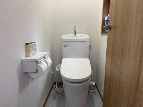 a bathroom with a white toilet in a room at ZenAbode茨城 in Ryūgasaki