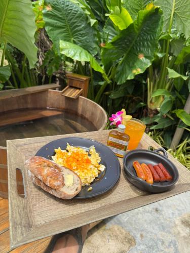 a tray with a plate of food and a plate of sausage and vegetables at Sea Salt Casa Bang Tao in Ban Thalat Choeng Thale