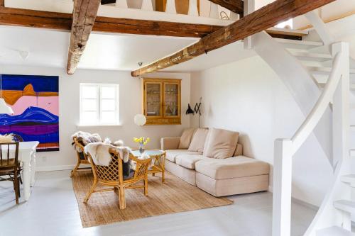 a living room with a couch and a table at Family-Friendly Oasis With Sea View In Funen in Nyborg