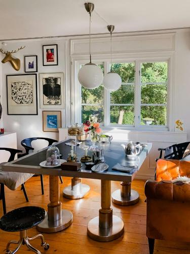 a living room with a table and a couch at Charming Artists House In Söderåkra in Söderåkra