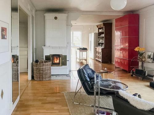 a living room with a couch and a fireplace at Charming Artists House In Söderåkra in Söderåkra