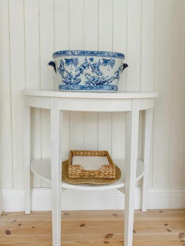 a white shelf with a blue and white bowl on it at Countryside Farm With Pool In Västergötland in Ljung