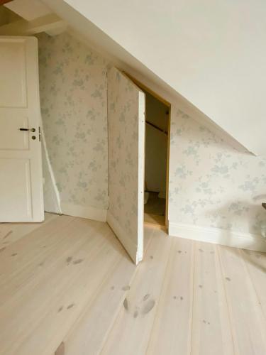 an empty room with an attic with a staircase at Countryside Farm With Pool In Västergötland in Ljung