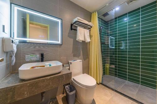 a bathroom with a toilet and a sink and a shower at GreenTree Inn Express Lanzhou West Passenger Station Lanzhou Center in Lanzhou