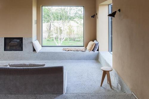 a living room with a large window and a couch at Architectural Gem On The Cornfield in Lindenhagen