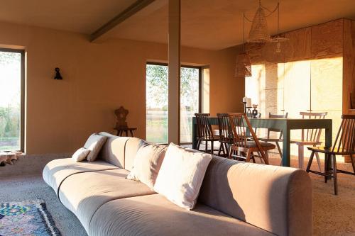 a living room with a white couch and a table at Architectural Gem On The Cornfield in Lindenhagen