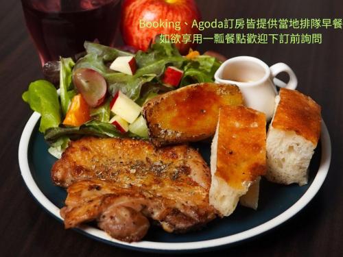 einen Teller mit Fleisch und Salat in der Unterkunft Yi Piao B&B in Zhushan