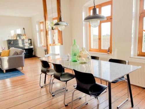 a dining table and chairs in a living room at Spacious Country House With Idyllic Orchard in Schönwalde