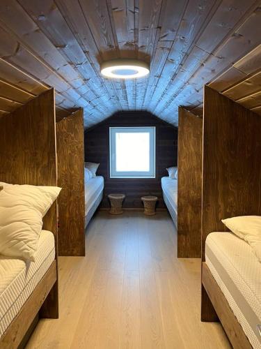 a room with two beds and a window at Mountain Home With View Near Tromsø in Kvaløya