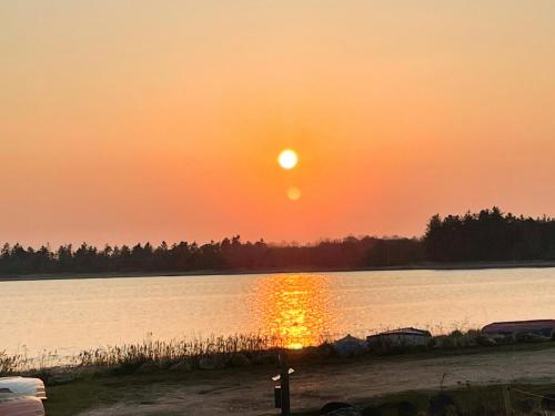 a sunset over a large body of water at Stunning Sunrises Over Harre Vig in Roslev
