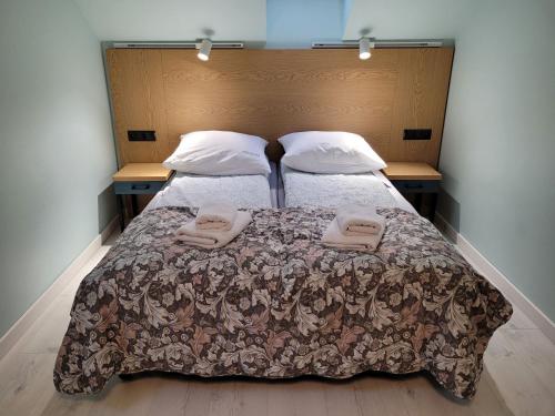 a bedroom with a bed with two towels on it at OW Krakus I - pokoje i domki in Stegna