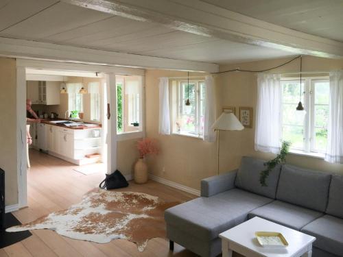 a living room with a couch and a table at Charming Country House Near Holten Beach in Nysted