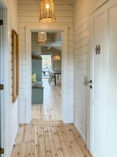 a hallway with a door leading to a dining room at Charming Log Cabin Close To The Water And Hou in Hou