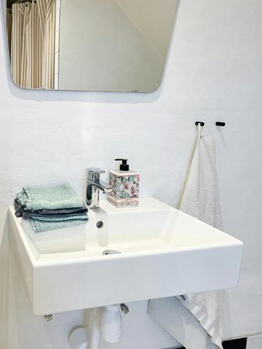 a bathroom with a white sink and a mirror at Live In Classic Skagen House In Skagen's Heart in Skagen