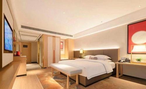 Ένα ή περισσότερα κρεβάτια σε δωμάτιο στο Echeng Hotel Enshi Minzu Road