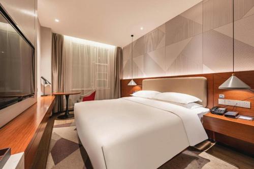 Ένα ή περισσότερα κρεβάτια σε δωμάτιο στο Borrman Hotel Xi'an North High-speed Railway Station
