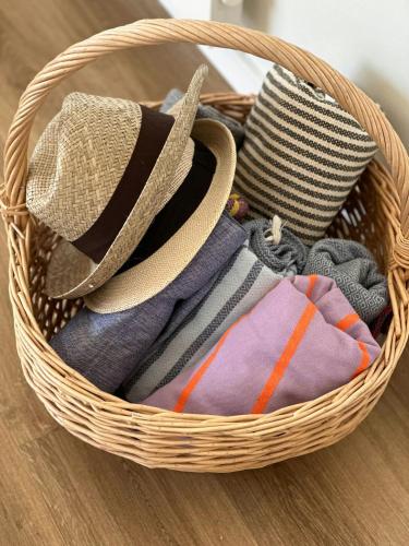 a basket filled with different types of towels at Architect-Designed Holiday Home By Lønstrup Beach in Hjørring
