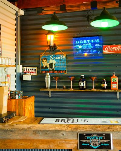 a bar with signs on the wall of a restaurant at Brett's Rest Nel in Kingscote